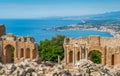Ruins of the Ancient Greek Theater in Taormina with the sicilian coastline. Province of Messina, Sicily, southern Italy.