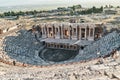 Ruins of ancient Hierapolis Amphi theatre with tourist Pamukkale, Denizili, Turkey. Evening sun Royalty Free Stock Photo