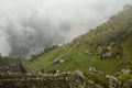 Ruins of the ancient Inca city machu picchu in fog, Peru