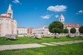 Ruins at the ancient Roman Forum in Zadar, Croatia. St. Mary`s Church in the background Royalty Free Stock Photo