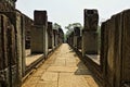 The ruins of the ancient temple of Angkor. The stone gallery on the castle terrace goes straight ahead.