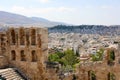 Ruins of ancient theater on the Acropolis with cityscape of Athenas. The Odeon of Herodes Atticus on the south slope