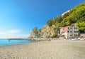 The ruins of the Aurora Tower Castle at Monterosso al Mare rise above the sandy beach in Cinque Terre, Italy Royalty Free Stock Photo