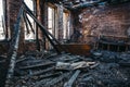 Ruins of burned brick house after fire disaster accident. Heaps of ash and arson, burnt furniture Royalty Free Stock Photo
