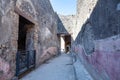 Ruins of the city of Pompeii: a narrow street of the ruined city. Pompeii, Campania, Italy