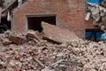 The ruins of collapsed houses, piles of brick construction waste