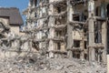 Ruins of destroyed houses, heaps of metal reinforcement concrete