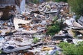 Ruins of a destroyed wooden house. Fragments of walls, boards, interior details. Summer sunny day.