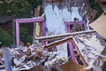 Ruins of a destroyed wooden house. Fragments of walls, boards, interior details. Summer sunny day.