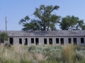 Dilapidated structure covered by shrubs at Glenrio, one of America`s ghost towns