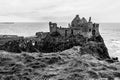 Ruins of Dunluce castle on the cliffs of the Atlantic Ocean in Northern Ireland in black and white Royalty Free Stock Photo