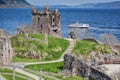 Ruins of Urquhart Castle against boat on Loch Ness in Scotland