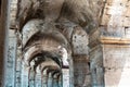 Ruins of the gated arch of the passage at the entrance of the Roman Colosseum in Rome, Italy Royalty Free Stock Photo