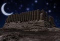 Ruins of the Great Kyz Kala located in ancient Merv in the Mary province, Turkmenistan at night with a new crescent moon on a sta