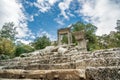 The ruins of Hadrian Gate in the ancient city of Termessos, framed by trees and a rocky foreground Royalty Free Stock Photo