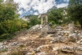 The ruins of Hadrian Gate in the ancient city of Termessos, framed by trees and a rocky foreground Royalty Free Stock Photo