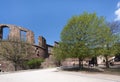 Ruins of Heidelberg castle - Closeup of detached tower with empty windows next to contrasting green trees in front of blue skye, c