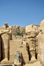 Ruins of Karnak Temple complex with sculptures and columns carved with ancient Egyptian hieroglyphs and symbols ancient Thebes. Royalty Free Stock Photo