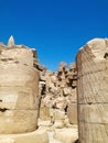 Ruins of Karnak Temple complex with statues, pylons, sculptures and columns carved with ancient Egyptian hieroglyphs and symbols Royalty Free Stock Photo