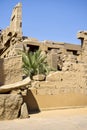 Ruins of Karnak Temple complex with statues, sculptures and columns carved with ancient Egyptian hieroglyphs and symbols Royalty Free Stock Photo