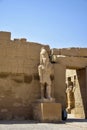 Ruins of Karnak Temple complex with statues, sculptures and pillars carved with ancient Egyptian hieroglyphs and symbols Royalty Free Stock Photo