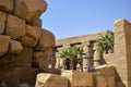 Ruins of Karnak Temple complex with statues, sculptures, pillars and columns carved with ancient Egyptian hieroglyphs and symbols Royalty Free Stock Photo