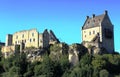 The main building and ruins of the Larochette Castle in Luxembourg wtth blue sky in the background