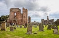 The ruins of Lindisfane Priory with Lindisfarne Castle in background, on Holy Island Northumberland, U Royalty Free Stock Photo