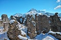 Historic ruins on mountain top in alpine landscape by blue sky in winter Royalty Free Stock Photo