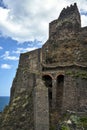 Ruins of a Norman castle on a volcanic cliff in the village of Aci Castello on the island of Sicily Royalty Free Stock Photo