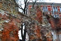 Ruins of old abandoned building of red and white bricks in contrast, against the backdrop of new brick house with beautiful window Royalty Free Stock Photo