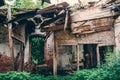 Ruins of old abandoned building room interior inside with fallen roof and overgrown with grass Royalty Free Stock Photo
