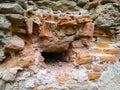 Ruins and old brick wall close up. Broken ancient brick wall with hole size of one brick. Concept destruction background Royalty Free Stock Photo
