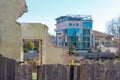 Ruins of old building with wooden fence and modern building background. Uzhgorod, Ukraine Royalty Free Stock Photo