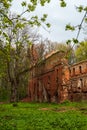 The ruins of the old castle made of brick in a clearing in the woods