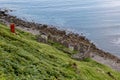 The ruins of old diatomite factory, rusty chimney and a blue ocean in Isle of Skye, Scotland