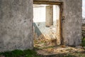 The ruins of an old earthen house without a roof. Holes in the wall at the site of windows and doors Royalty Free Stock Photo