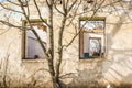 The ruins of an old earthen house without a roof. Holes in the wall at the site of windows and doors Royalty Free Stock Photo