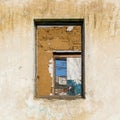 The ruins of an old earthen house without a roof. Holes in the wall at the site of windows and doors