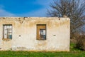 The ruins of an old earthen house without a roof. Holes in the wall at the site of windows and doors Royalty Free Stock Photo