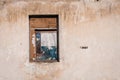 The ruins of an old earthen house without a roof. Holes in the wall at the site of windows and doors Royalty Free Stock Photo