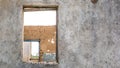 The ruins of an old earthen house without a roof. Holes in the wall at the site of windows and doors Royalty Free Stock Photo