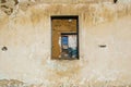 The ruins of an old earthen house without a roof. Holes in the wall at the site of windows and doors Royalty Free Stock Photo