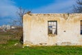 The ruins of an old earthen house without a roof. Holes in the wall at the site of windows and doors Royalty Free Stock Photo