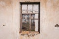 The ruins of an old earthen house without a roof. Holes in the wall at the site of windows and doors