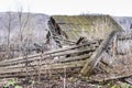 Ruins of old farm in countryside. Aged broken wooden buildings