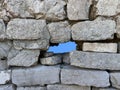 Ruins of an old fortress, a hole in the stone. Hole in the ancient fortress wall. Brick structure with a through hole Royalty Free Stock Photo