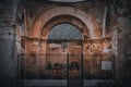 Ruins of an old religious building with columns and arches fenced by metal gate in Antigua, Guatemala Royalty Free Stock Photo