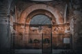 Ruins of old religious building with columns and arches fenced by metal gate in Antigua, Guatemala Royalty Free Stock Photo