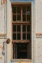 Ruins of an old school in the city. High window of a dilapidated large building